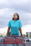 Woman wearing RENQARA Aqua Drift Classic Tee in a shopping cart editorial streetwear look.