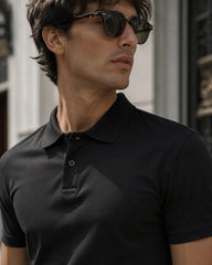 RENQARA Black Polo T-Shirt close-up on male model showing collar, buttons and upper fit