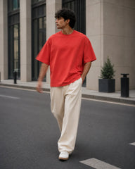 RENQARA Brick Red Oversized T-Shirt worn in a relaxed walking pose showing oversized fit and sleeve fall