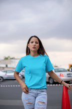 Woman wearing RENQARA Aqua Drift Classic Tee in a casual parking streetwear outfit.