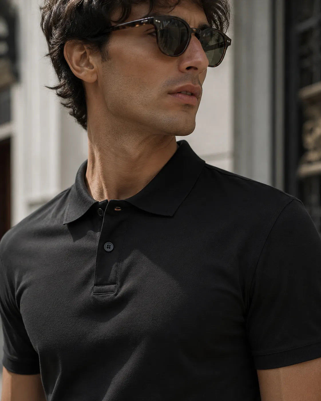 RENQARA Black Polo T-Shirt close-up on male model showing collar, buttons and upper fit