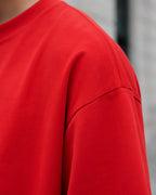 RENQARA Crimson Red Oversized T-Shirt close-up showing dropped shoulder seam, sleeve construction and smooth cotton texture