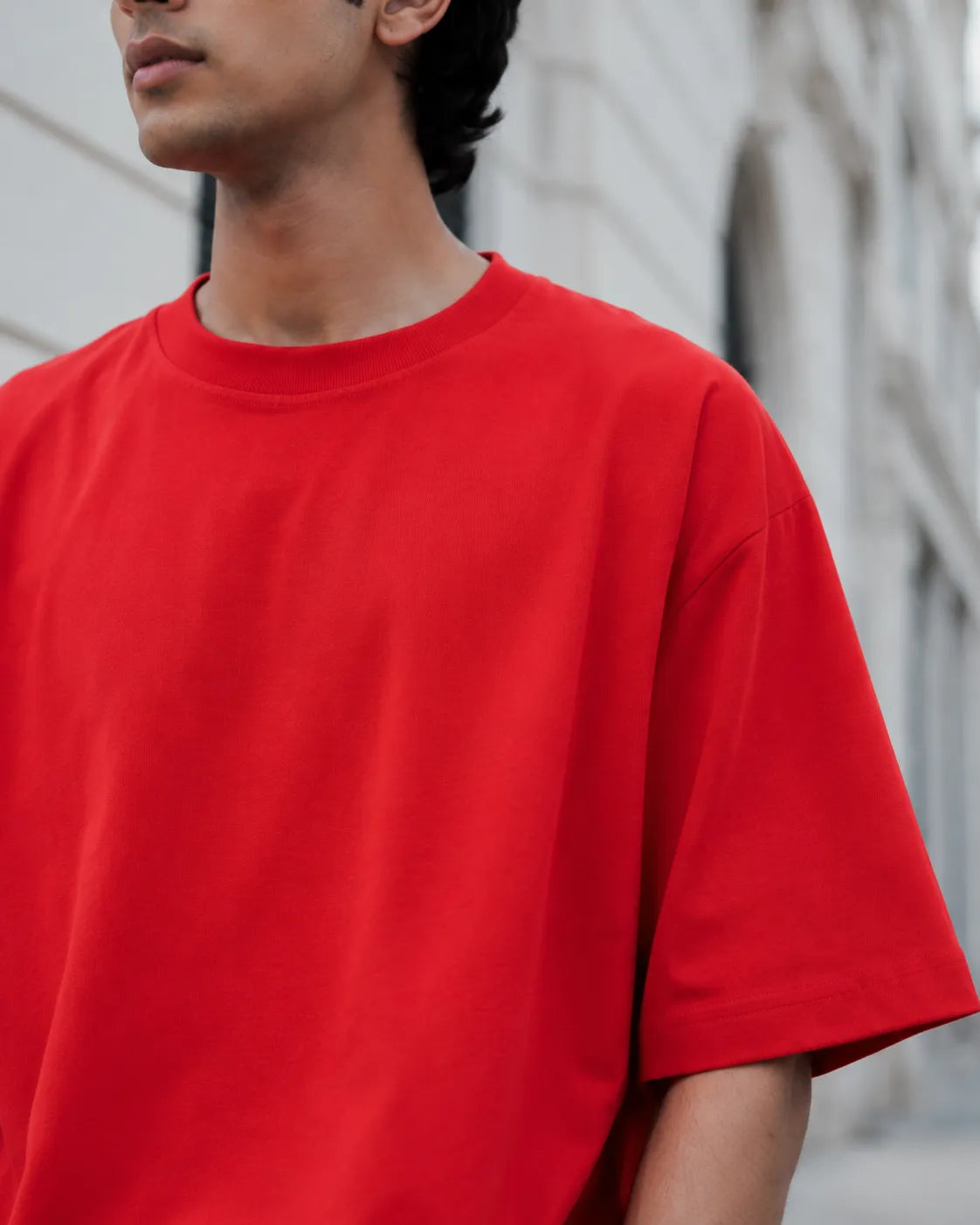 RENQARA Crimson Red Oversized T-Shirt close-up showing crew neck, shoulder drop and cotton fabric texture