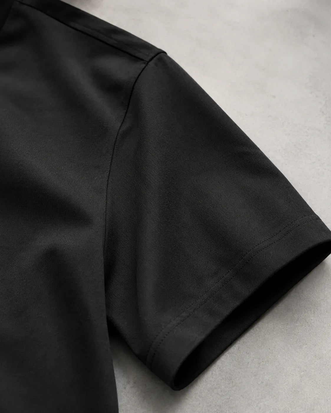 RENQARA Onyx Supima T-Shirt sleeve detail showing smooth black Supima cotton fabric and clean stitching