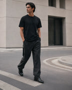 RENQARA Onyx Supima T-Shirt worn in a relaxed walking pose with minimal black styling