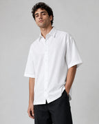 Male model wearing RENQARA White Flow Collar Shirt, oversized half-sleeve cotton shirt styled with black trousers for clean everyday wear.
