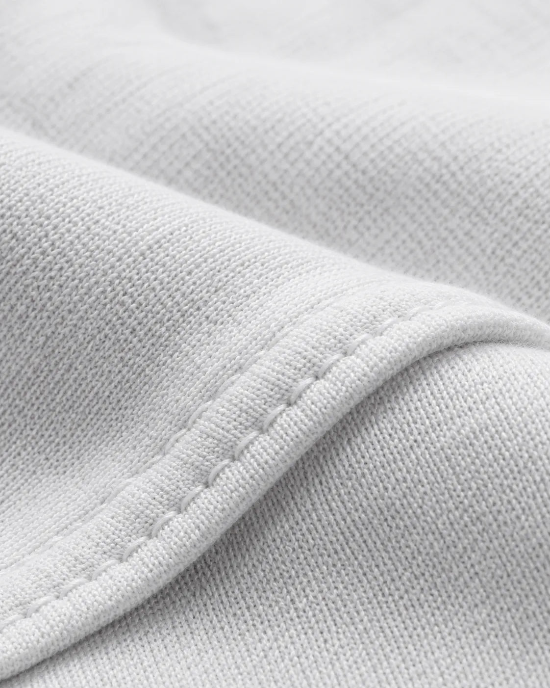 Close-up of the premium 230 GSM piqué cotton fabric used in the RENQARA White Polo T-Shirt.
