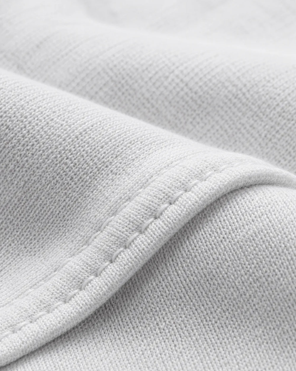 Close-up of the premium 230 GSM piqué cotton fabric used in the RENQARA White Polo T-Shirt.