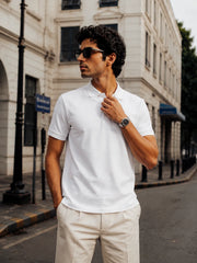 Model wearing the RENQARA White Polo T-Shirt paired with cream trousers for a refined smart-casual look.
