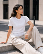 RENQARA White Women’s Regular Fit T-Shirt seated lifestyle look styled with beige trousers and white sneakers