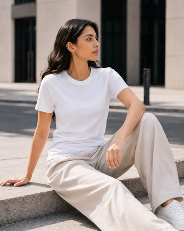 RENQARA White Women’s Regular Fit T-Shirt seated lifestyle look styled with beige trousers and white sneakers