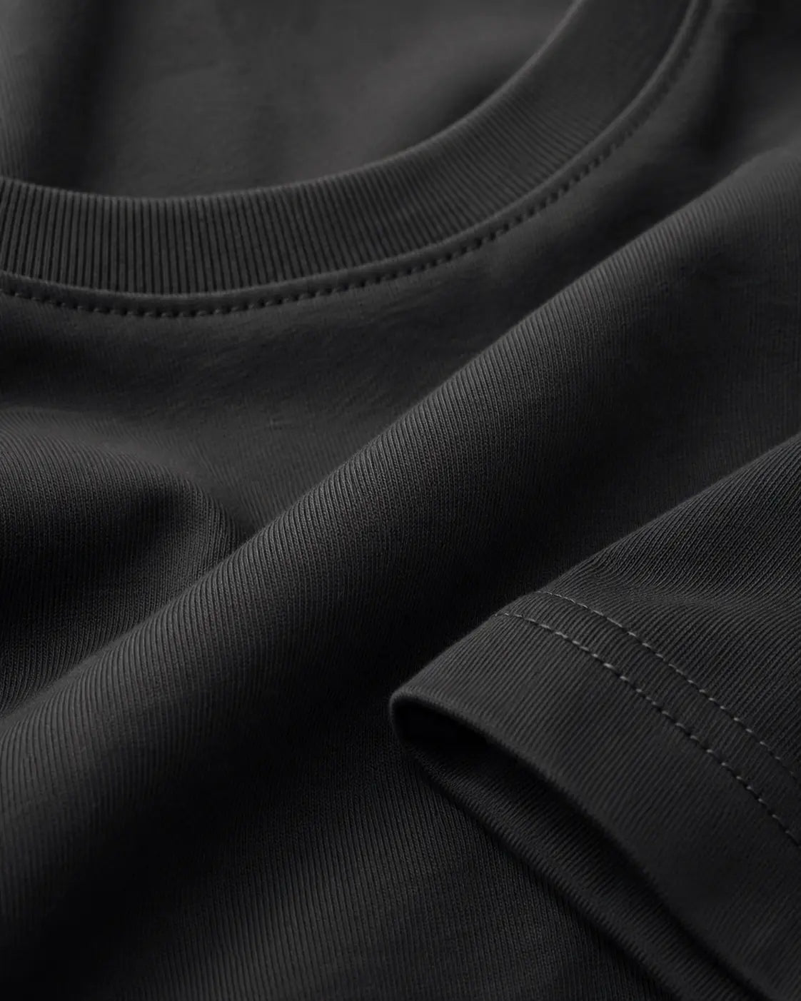 RENQARA Women’s Black Regular Fit T-Shirt close-up showing round neck rib, sleeve stitching and black cotton fabric texture