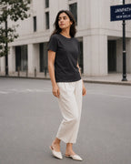 RENQARA Women’s Black Regular Fit T-Shirt front fit on female model styled with white trousers
