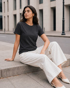 RENQARA Women’s Black Regular Fit T-Shirt on female model in a seated casual look showing regular fit and soft drape