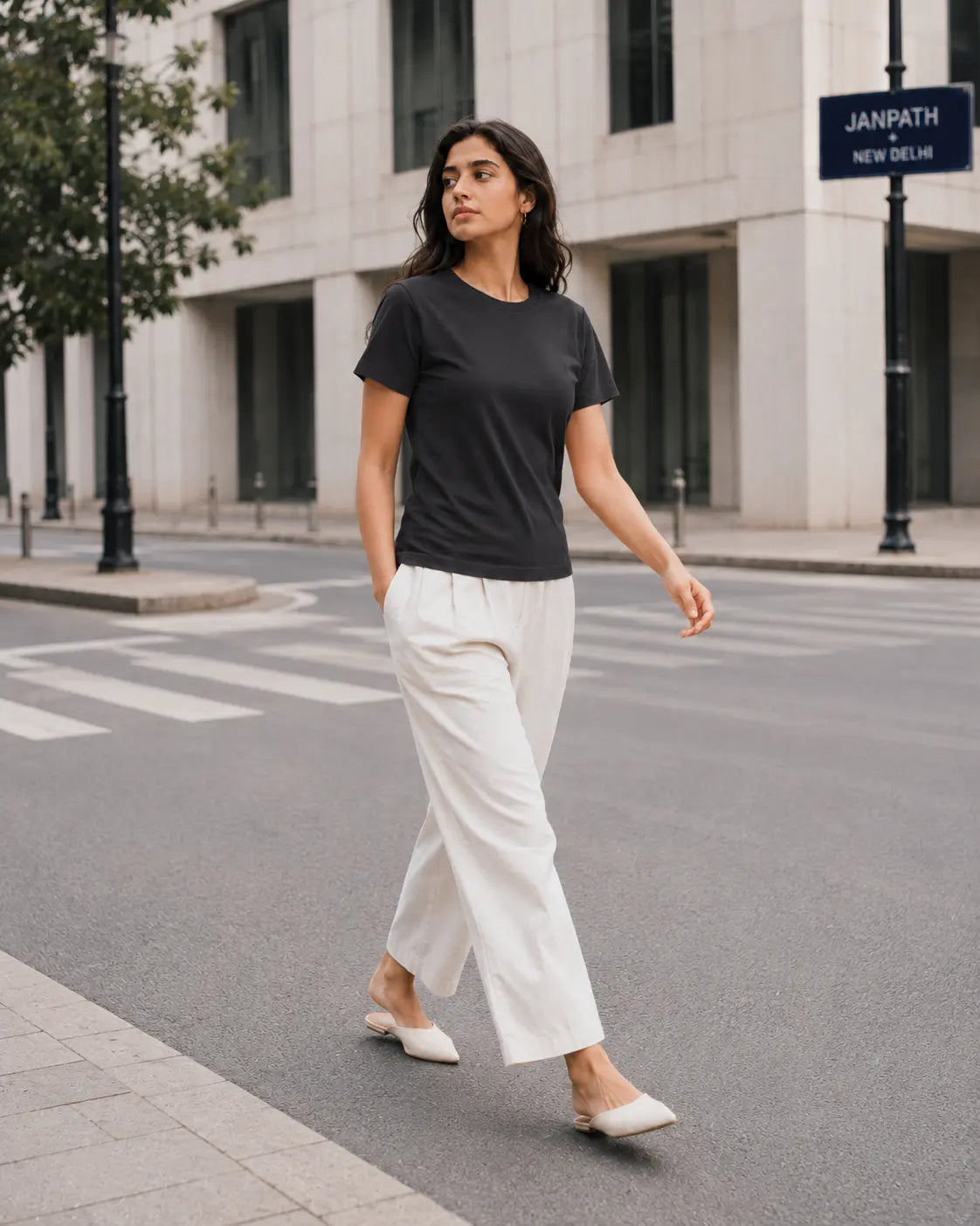 RENQARA Women’s Black Regular Fit T-Shirt worn in a clean street-style walking look with white trousers